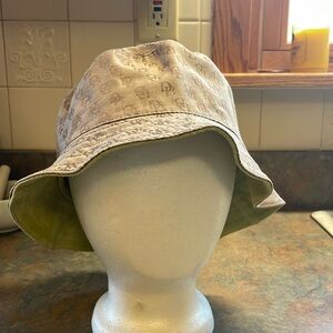 Dooney & Bourke reversible hat. Tan/brown sig fabric and spring green suede.